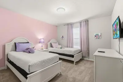 two beds in a room with pink walls at Lavish Villa W Private Pool And Spa And Free Resort in Orlando