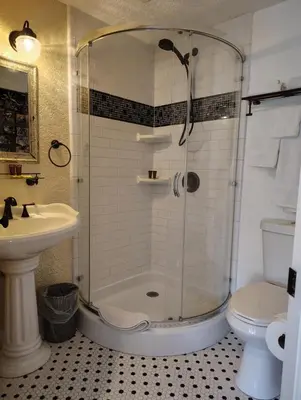a bathroom with a shower and a sink and a toilet at Kapp and Kappy Bed & Breakfast in Kissimmee