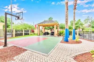 a basketball court with a gazebo and a basketball hoop at Spacious Suite close to Disney w Pool Hot Tub Arcade in Orlando