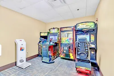 a room with arcade games and a video game system at Spacious Suite close to Disney w Pool Hot Tub Arcade in Orlando