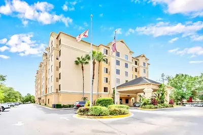 a hotel with a flag on top of it at Spacious Suite close to Disney w Pool Hot Tub Arcade in Orlando