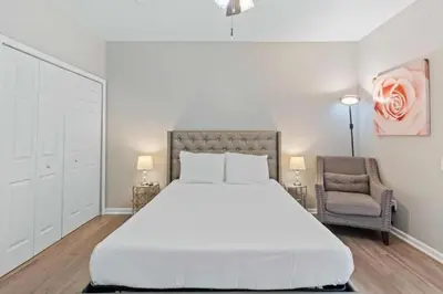 a bedroom with a large white bed and a chair at Apartamento 3 Quartos no Vista Cay Resort in Orlando