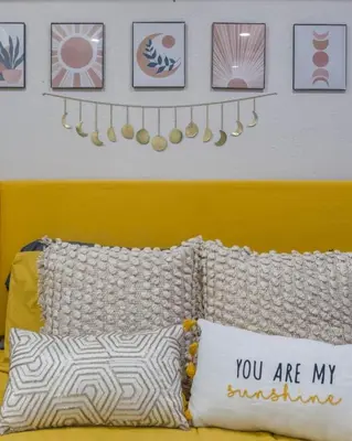 a bedroom with a bed with a yellow headboard and some pictures at CUTE and COZY studio w jacuzzi in Orlando