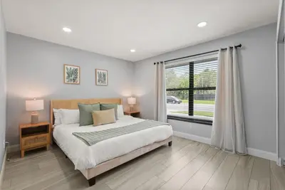 a bedroom with a large bed and a window at Modern Escape Near Lake Eola and Downtown Orlando in Orlando
