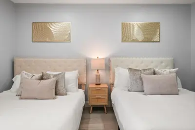 two beds sitting next to each other in a bedroom at Modern Escape Near Lake Eola and Downtown Orlando in Orlando