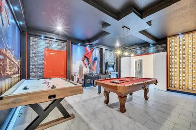 a room with a pool table and a tv at Mahuna Matata in Kissimmee