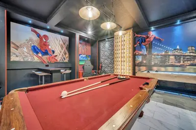 a billiard room with a pool table and paintings at Mahuna Matata in Kissimmee