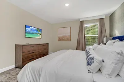 a bedroom with a large white bed and a window at Mahuna Matata in Kissimmee
