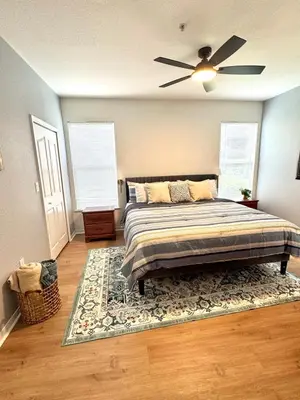 a bedroom with a bed and a ceiling fan at Wonderful apt remodeled in November near Disney in Kissimmee