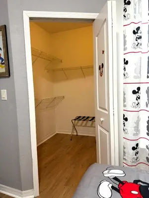 a bedroom with a door open to a walk in closet at Wonderful apt remodeled in November near Disney in Kissimmee