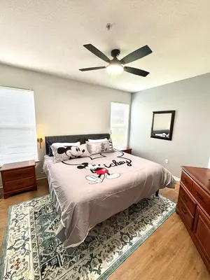 a bedroom with a bed with a ceiling fan at Wonderful apt remodeled in November near Disney in Kissimmee