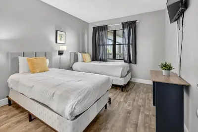 a bedroom with two beds and a television in it at 6165 CD Unit 3603 - Enclave at Orlando Condo in Orlando