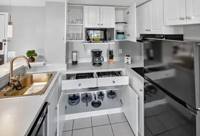 a kitchen with white cabinets and a sink at 6165 CD Unit 3603 - Enclave at Orlando Condo in Orlando