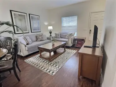 a living room with a couch and a table at Casa 3Q Lucaya Village — 15min da Disney in Kissimmee