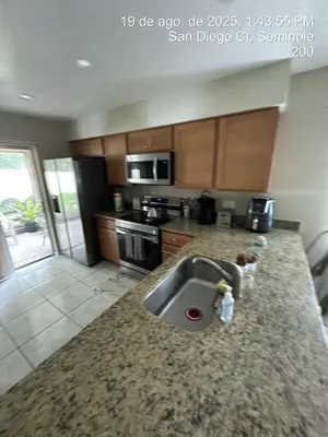 a kitchen with a sink and a counter top at Maxx Maximum Comfort LLC in Orlando