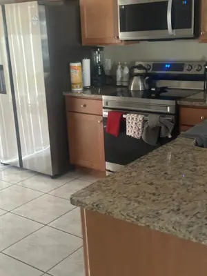 a kitchen with a stove and a counter top at Maxx Maximum Comfort LLC in Orlando