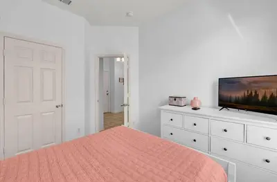 a bedroom with a bed and a flat screen tv at Mickeys Villa in Kissimmee