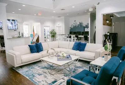 a living room with a white couch and blue chairs at Cozy 3 BD Townhome 2 king beds Close to Disney 1503 in Kissimmee