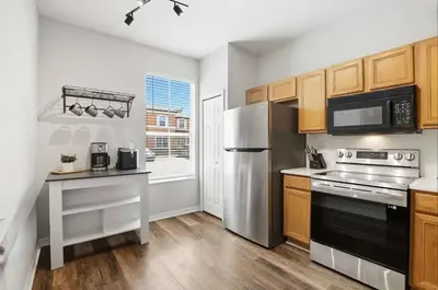 a kitchen with a stainless steel refrigerator and a stove at Park Hopper Paradise At Regal Oaks in Orlando