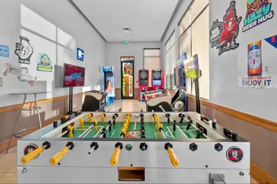 a play room with a foosball table in the middle at Park Hopper Paradise At Regal Oaks in Orlando