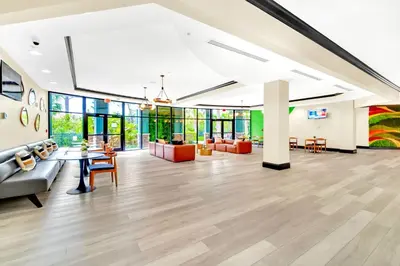 an office lobby with a couch and tables and chairs at Family Fun Condo Pool and Sauna near Disney in Orlando
