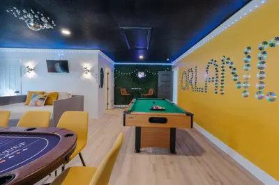 a room with a pool table and a ping pong ball at Entire Home with Pool, Ping Pong Table and Arcade games in Kissimmee