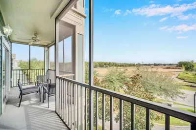 a balcony with a table and chairs and a view at Upstay Pet Friendly Condo 6 Minutes from Disney in Orlando