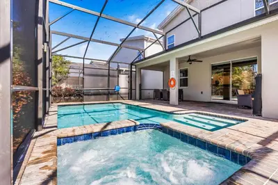 an indoor swimming pool in a house with a glass ceiling at New Storey Lake Dream Family Escape in Kissimmee