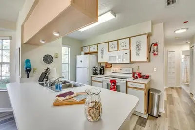 a kitchen with a vase on a kitchen counter at DisneyCondo 10 PP Mr Fredricksen House in Kissimmee
