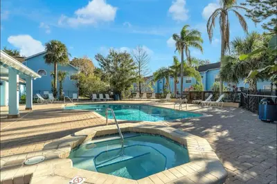 a swimming pool in a yard with palm trees at DisneyCondo 10 PP Mr Fredricksen House in Kissimmee