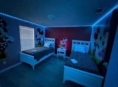 a bedroom with two beds and a blue room at Family Home 20 min Disney 4BR Heated Pool BBQ in Kissimmee
