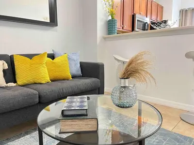 a living room with a couch and a glass table at Magic Home! GREAT Spot - 15Min Disney20 Universal in Kissimmee