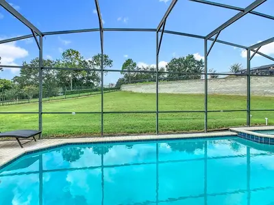 a swimming pool with a view of a field at 4BR Luxury Villa, Pool & GameRoom in Windsor Hills in Orlando