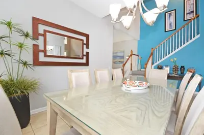 a dining room with a table and a mirror at Ohana Haven home in Orlando