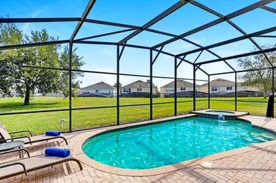 a swimming pool with a pergola and a swimming poolvisor at Ohana Haven home in Orlando