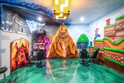 a room with a dinosaur painting on the wall at Mansão 8Q Disney c/ Cinema, Game Room, Piscina in Orlando