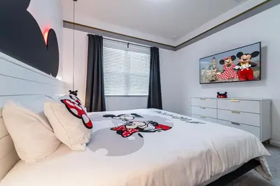 a bedroom with a bed with a hello kitty comforter at Mansão 8Q Disney c/ Cinema, Game Room, Piscina in Orlando
