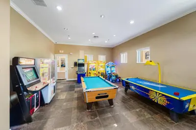 a play room with a pool table and arcade machines at 4704 Flagler Beach Way in Kissimmee