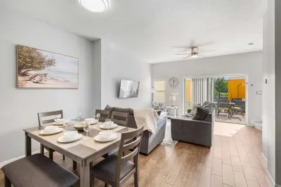 a dining room and living room with a table and chairs at 4704 Flagler Beach Way in Kissimmee