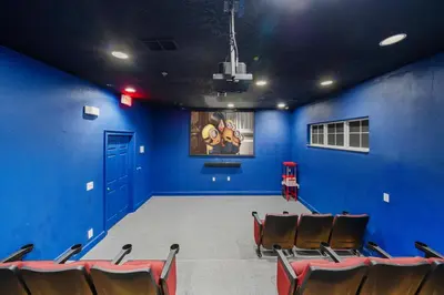 an empty room with blue walls and brown chairs at 4704 Flagler Beach Way in Kissimmee