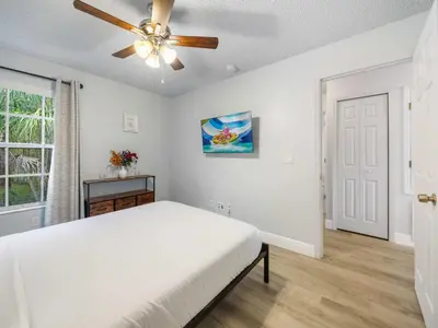 a white bedroom with a bed and a ceiling fan at 5005 Laguna Bay Cir 18 in Kissimmee