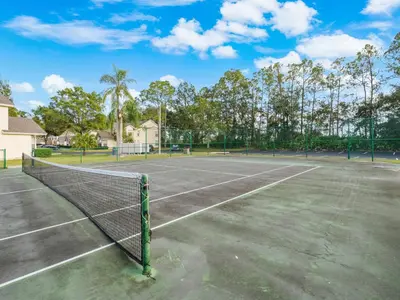 a tennis court with a net at 5005 Laguna Bay Cir 18 in Kissimmee