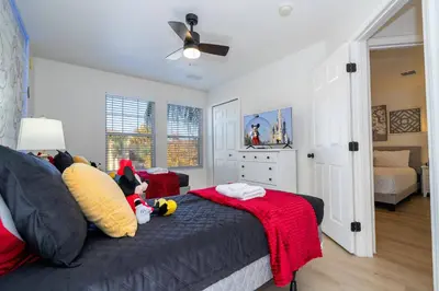 a bedroom with a bed with stuffed animals on it at Cozy 4 BR close to Disney in Kissimmee