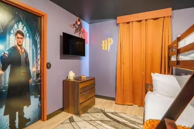 a bedroom with a bed and a poster of a man at 3 Bedroom 8 Miles from Disney Word in Kissimmee