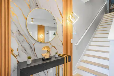 a hallway with a mirror and a staircase at 3 Bedroom 8 Miles from Disney Word in Kissimmee