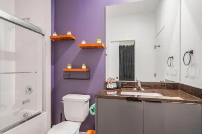 a purple bathroom with a toilet and a sink at 3 Bedroom 8 Miles from Disney Word in Kissimmee