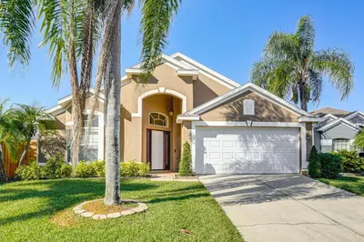 a house with palm trees in front of it at Apopka Family Home with Yard, 13 Mi to Dtwn Orlando in Orlando