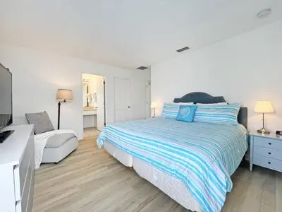 a white bedroom with a bed and a couch at Endless Summer home in Kissimmee