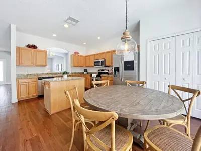 a kitchen with a table and chairs in a kitchen at Endless Summer home in Kissimmee