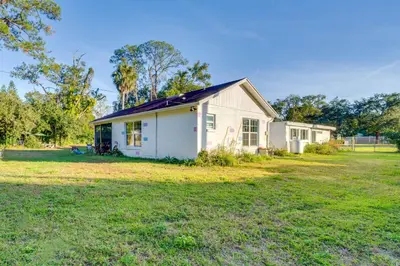 a small white house in a field of grass at 1 Mi to Historic Dtwn Sanford! Pet-Friendly Unit in Sanford